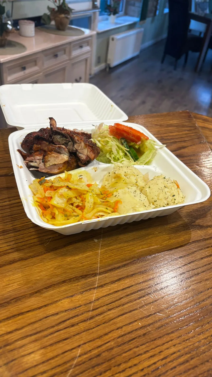 A SKN Eats takeaway meal with chicken and sides